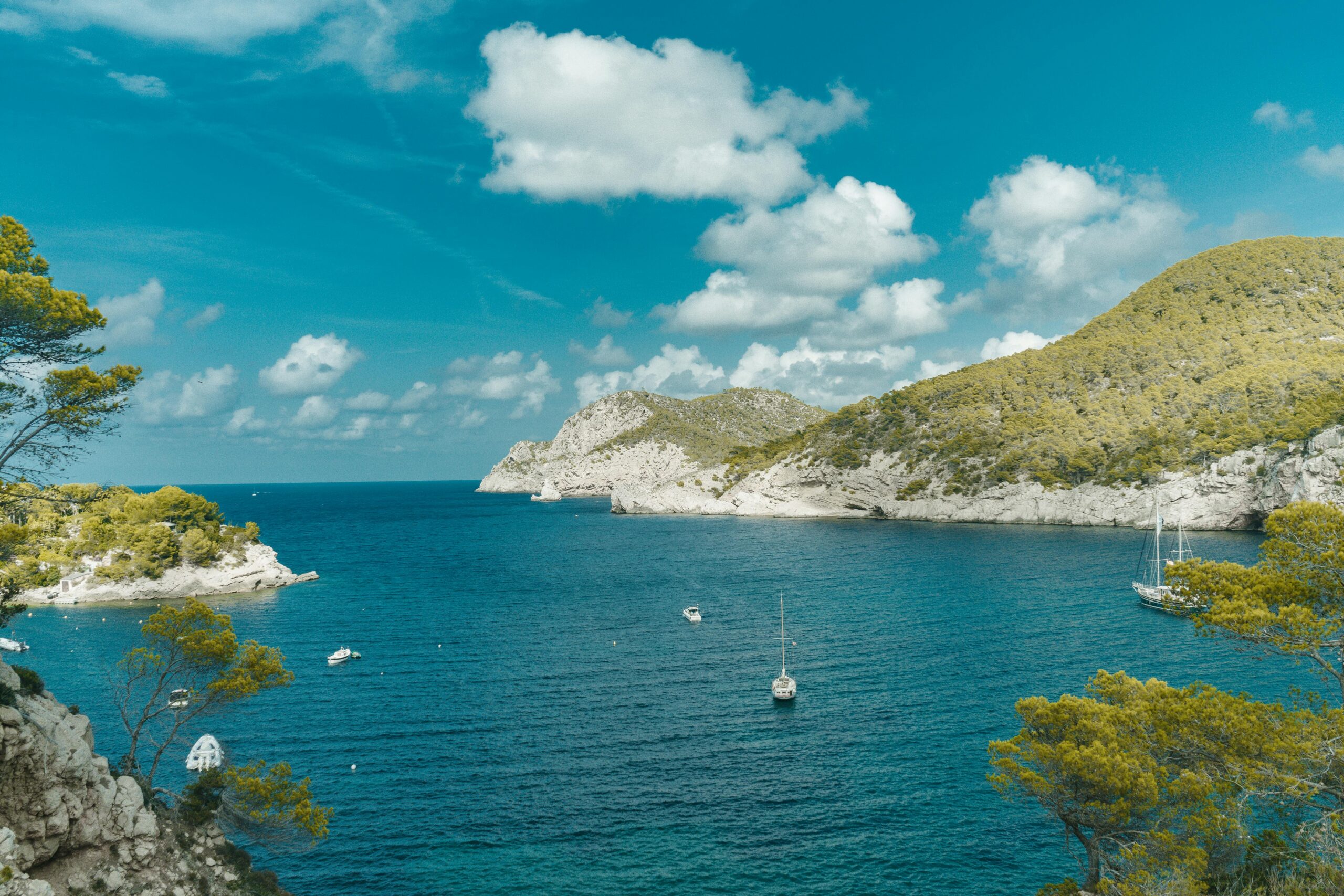 Stunning summer view of the Mediterranean Sea with sailboats in Ibiza, Spain.
